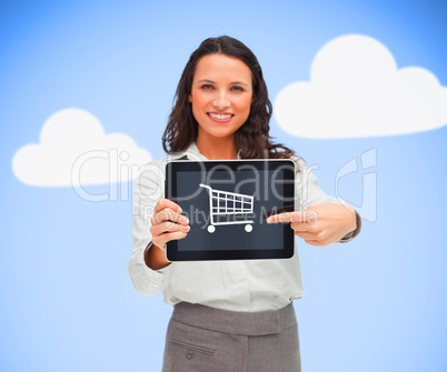 Businesswoman holding a tablet pc while smiling showing trolley