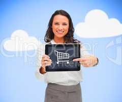 Businesswoman holding a tablet pc while smiling showing trolley