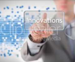 Businessman standing while pointing to the word innovation