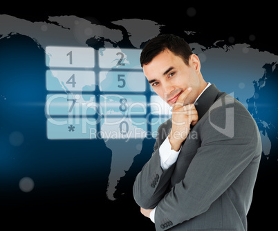 Businessman standing in front of number pad hologram