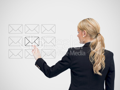 Businesswoman standing touching a message symbol