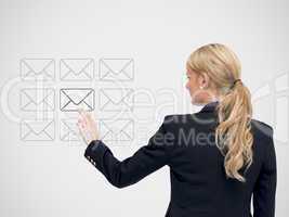 Businesswoman standing touching a message symbol