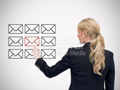 Businesswoman standing while touching at red message symbol