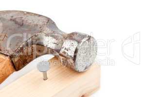 Nail sticking in a plank with a hammer
