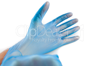 Man putting on rubber gloves