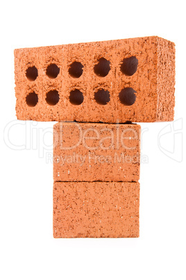 Three clay bricks being stacked