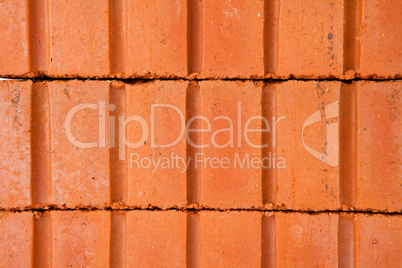 Stack of clay bricks building a wall