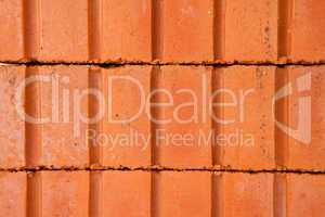 Stack of clay bricks building a wall