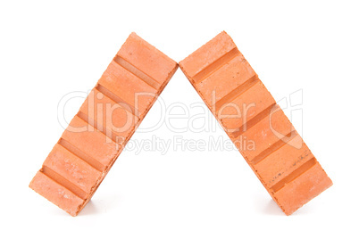 Two clay bricks leaning against each other