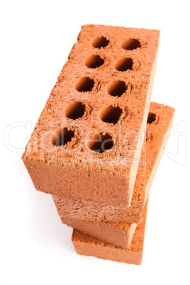 Four clay bricks being stacked