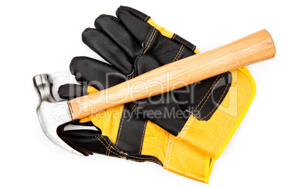 Hammer lying on two leather gloves