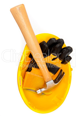 Two leather gloves and a hammer lying in a helmet