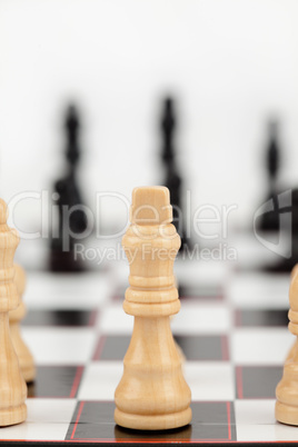 White queen standing at the chessboard