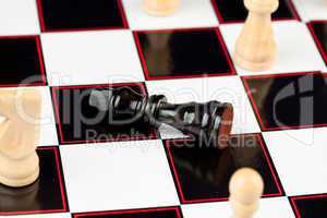 Black chessman lying