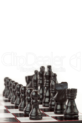 Black chess pieces standing at the chessboard