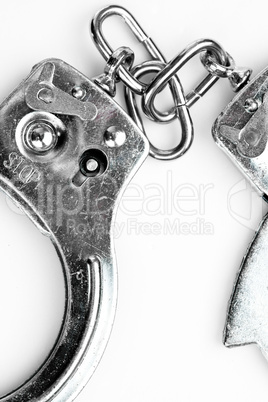 Handcuffs lying against white background