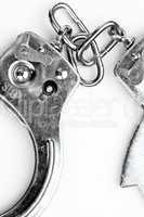 Handcuffs lying against white background