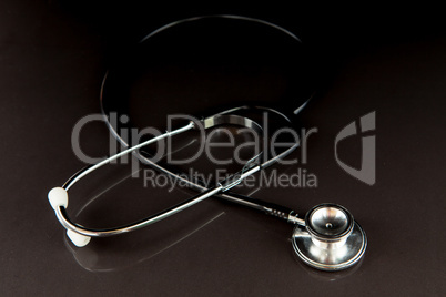 Metal black stethoscope in the dark