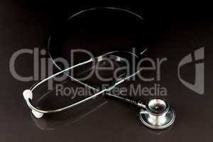 Metal black stethoscope in the dark