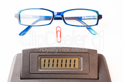 Sector of calculator display with glasses and paper clip