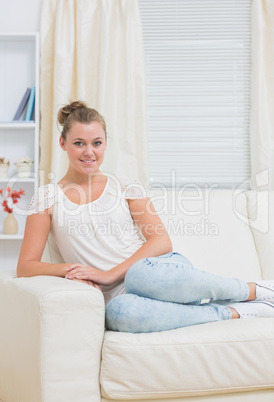 Smiling blonde on sofa