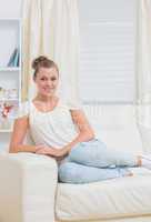 Smiling blonde on sofa