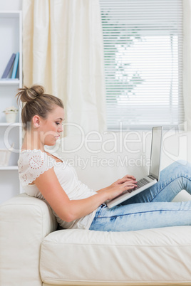 Woman working on laptop on the couch