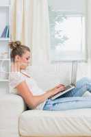 Woman working on laptop on the couch