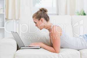 Woman using notebook while relaxing