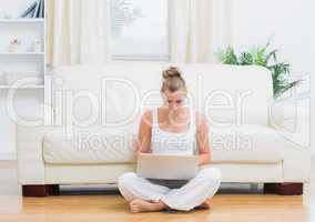 Blonde sitting on the floor with laptop