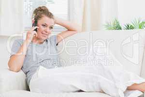 Joyful woman calling and relaxing