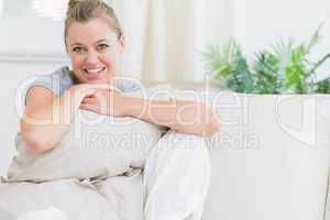 Cheerful woman holding a pillow