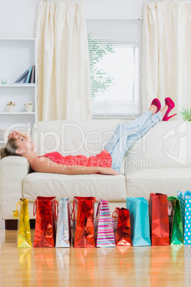 Woman relaxing on the sofa after shopping