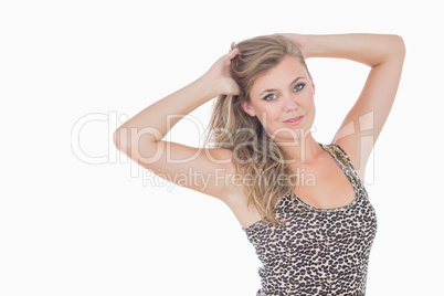Blonde woman holding her hair and looking glamorous