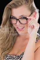 Sultry woman holding her glasses