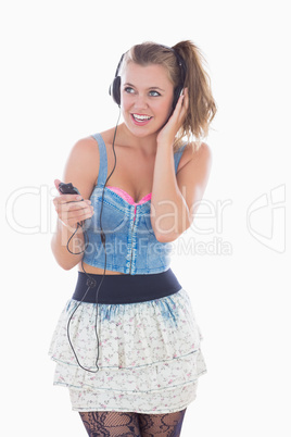 Blonde woman listening to music while smiling