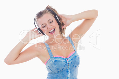 Woman singing while listening to music