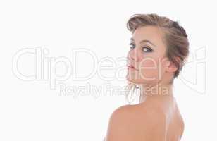Nude woman looking over her shoulder