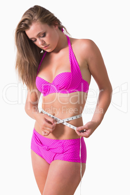 Woman measuring her waist