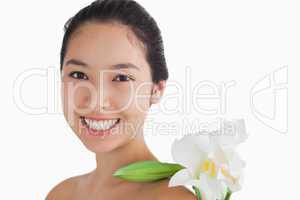 Joyful woman having a flower on her shoulder
