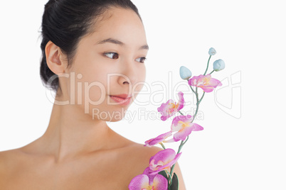 Woman looking at a bouquet of orchids