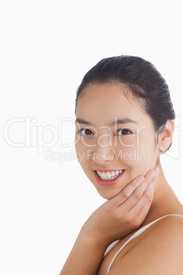 Woman smiling while touching face