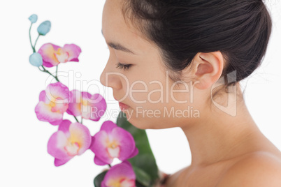 Woman smelling on orchids