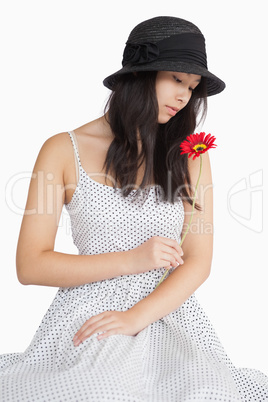 Woman looking at a flower