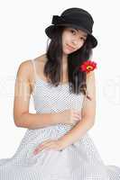Woman holding flower in a polka dot dress