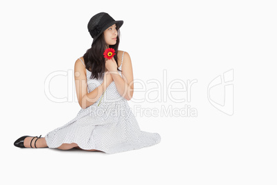 Woman sitting on the floor looking away