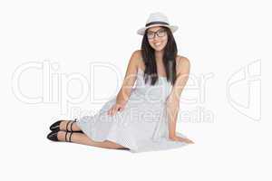 Woman sitting on the floor wearing glasses