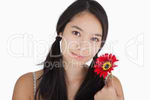 Smiling woman holding flower