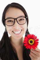 Happy woman holding a flower with glasses