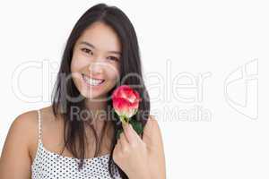 Smiling woman holding a rose